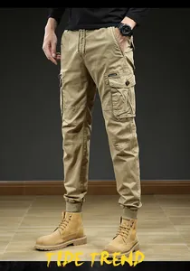 Detail view of men's khaki cargo pants featuring multi-pockets and elastic jogger cuffs.