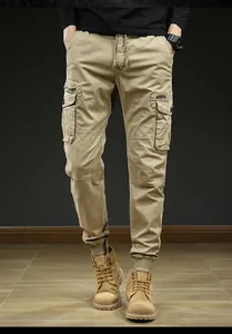 Detailed view of men's khaki cargo jogger pants featuring functional multiple utility pockets