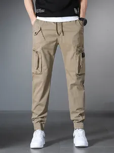 Men's khaki multi-pocket cargo jogger pants with drawstring and elastic waist for outdoor.