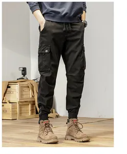Close-up detail of men's American vintage black cargo jogger pants styled with boots