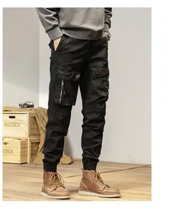 Close-up of black multi-pocket cargo pants with elastic cuffs and vintage styling