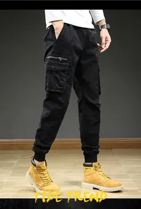 Detailed close-up of men's vintage black cargo joggers with functional multi-pockets