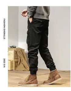 Detail view of men's vintage multi-pocket cargo pants with jogger cuffs in black