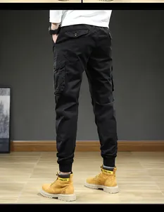 Detail view of men's black cargo joggers showing multi-pockets and elastic cuffs