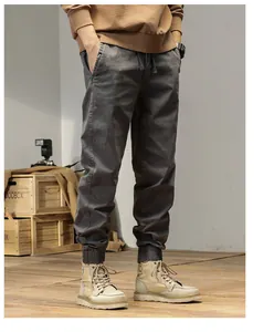 Detailed side view of men's dark grey retro cargo joggers featuring elasticated ankle cuffs