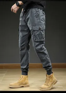 Detailed side view of men's grey retro cargo jogger pants featuring multiple utility pockets