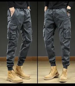 Detail view of men's vintage multi-pocket cargo jogger pants in charcoal grey color