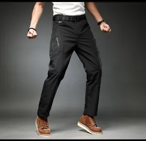 Detail view of men's black cargo pants featuring multi-pockets and tactical belt