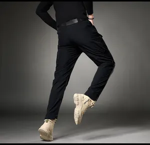 Dynamic back view of a man wearing black slim-fit cargo pants and beige tactical boots