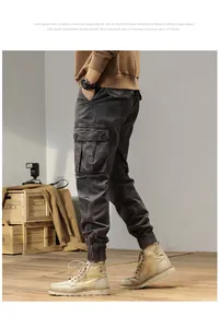 Side view of men's dark grey vintage cargo jogger pants in a studio setting.