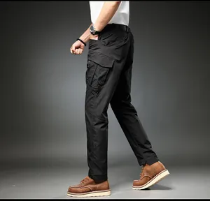 Close-up detail showing the side cargo pockets and slim fit of black multi-pocket pants