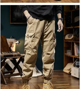 Detailed close-up of men's khaki retro cargo pants featuring large side pockets and elastic cuffs