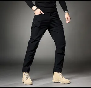 Close-up detail of mens black slim-fit cargo pants with tactical multi-pocket design