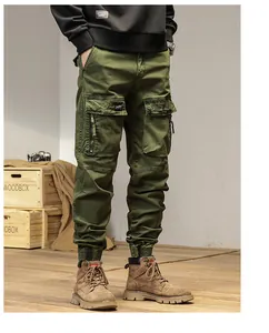 Detailed view of men's olive green multi-pocket cargo joggers in vintage style