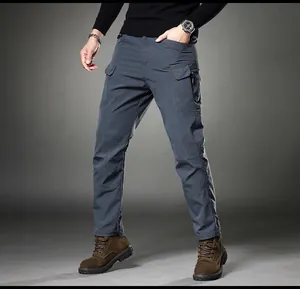 Detail of men's slim fit stretch cargo pants in dark grey with vintage straight leg style.