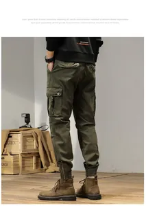 Detail view of men's vintage army green cargo pants showing side pockets and ankle zipper