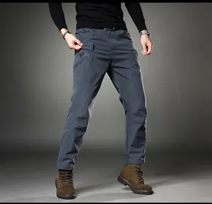 Detail view of men's slim fit stretch cargo pants with multiple utility pockets.