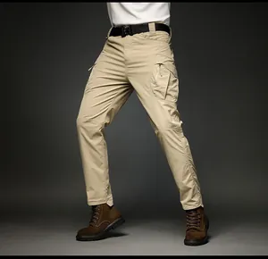 Detail view of men's khaki cargo pants featuring multi-pocket and tactical design