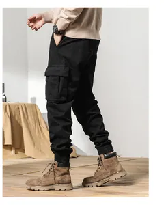 Side view of black fleece-lined tapered cargo pants with large utility side pockets.