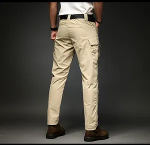 Rear view detail of men's khaki cargo pants featuring functional side flap pockets