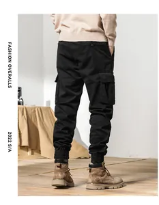 Men's vintage black cargo pants featuring elastic tapered cuffs and multi-pocket design