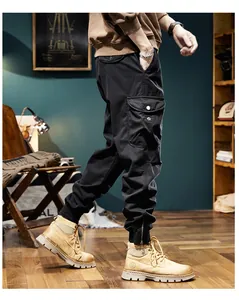 Side view detail of men's vintage black cargo pants with large side pocket and elastic cuffs