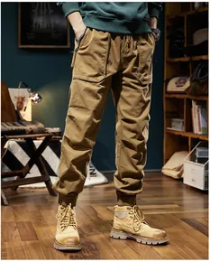 Detail of men's khaki vintage cargo pants with elastic cuffs and large pockets