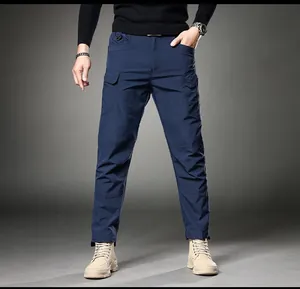 Front view of men's slim fit navy blue cargo pants with functional side pockets and D-ring