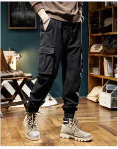 Gros plan d'un pantalon cargo jogger noir rétro pour hommes avec poches.