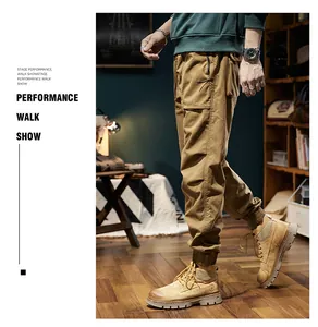 Close-up of mens retro loose cargo pants paired with work boots in a lifestyle setting