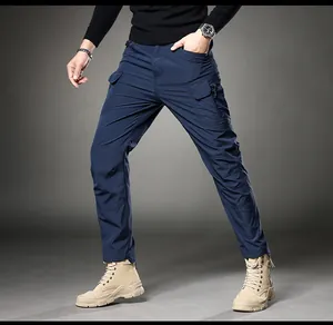 Detailed view of men's navy blue slim fit cargo pants featuring tactical side pockets