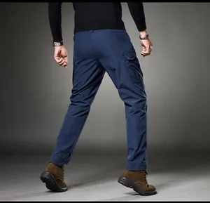 Back view of men's navy blue cargo pants with side pockets and brown boots for outdoors