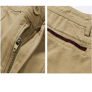 Detailed view of the metal zipper fly and striped pocket design on khaki cargo shorts