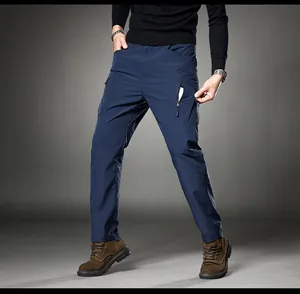 Detail showing the zipper pocket and fabric of navy blue men's cargo pants.
