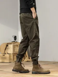 Men's retro army green cargo jogger pants with elastic cuffs and pocket details.