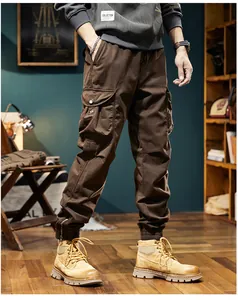 Close-up detail of men's vintage brown cargo joggers featuring large side utility pockets.