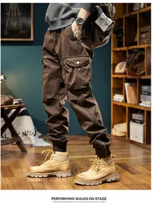 Detailed side view of vintage brown cargo jogger pants for men with adjustable zip cuffs