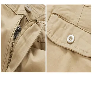 Close-up detail of khaki cargo shorts showing heavy-duty metal zipper and button pocket.