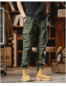 High-quality detail of men's army green cargo jogger pants with multiple pockets