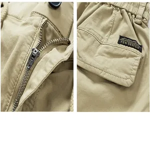 Close-up details of khaki cargo shorts showing the metal zipper and pocket patch.