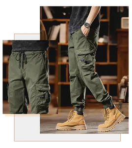 Macro detail showing olive green men's cargo jogger pants with multiple pockets.