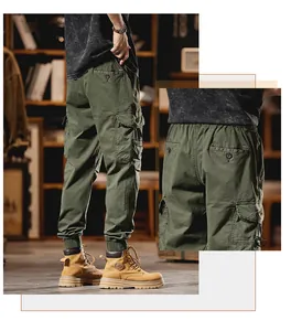 Detailed view of men's green multi-pocket cargo joggers with elastic cuffs and street style