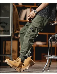 Detail view of men's olive green multi-pocket cargo pants with jogger cuffs.