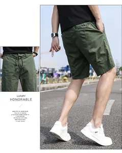 Detailed view of men's vintage olive green cargo shorts featuring an elastic drawstring waist.