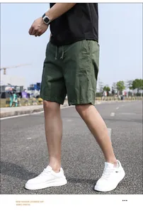 Men's army green vintage casual cargo shorts shown in an outdoor street setting.
