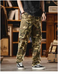 Detail view of vintage camouflage cargo pants with multi-pockets on a model in a studio