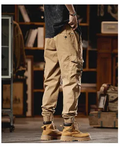 Side view of men's khaki cargo jogger pants with multiple pockets and elastic cuffs