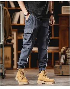 Detailed shot of men's multi-pocket blue cargo joggers with elastic cuffs and street style