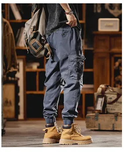 Detailed view of men's blue cargo joggers with multi-pockets and elastic cuffs