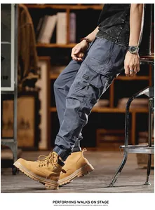 Close-up detail of men's slate blue multi-pocket cargo joggers in a vintage workshop